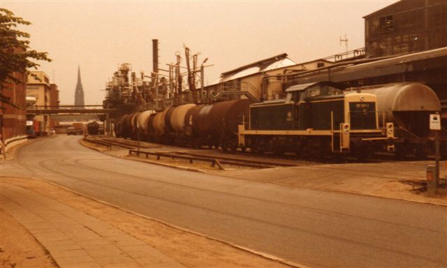 DB 291 027-1 rangerer med sovjettiske og bulgarske tankvogne i 1983. Jeg har noteret rumindhold: 60 kubikmeter. Vedligeholdelsestilstand: Slet. I baggrunde en af Hambor kirker, men Norderelbe er imellem!